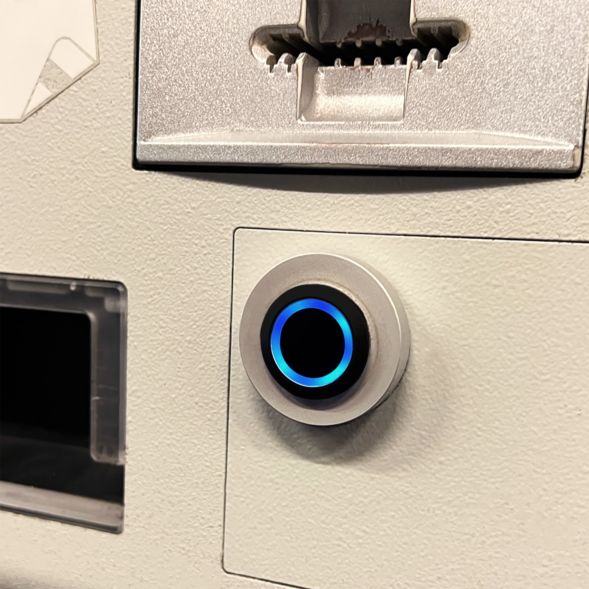 Black Billet Button with Blue Illumination Installed on Machine